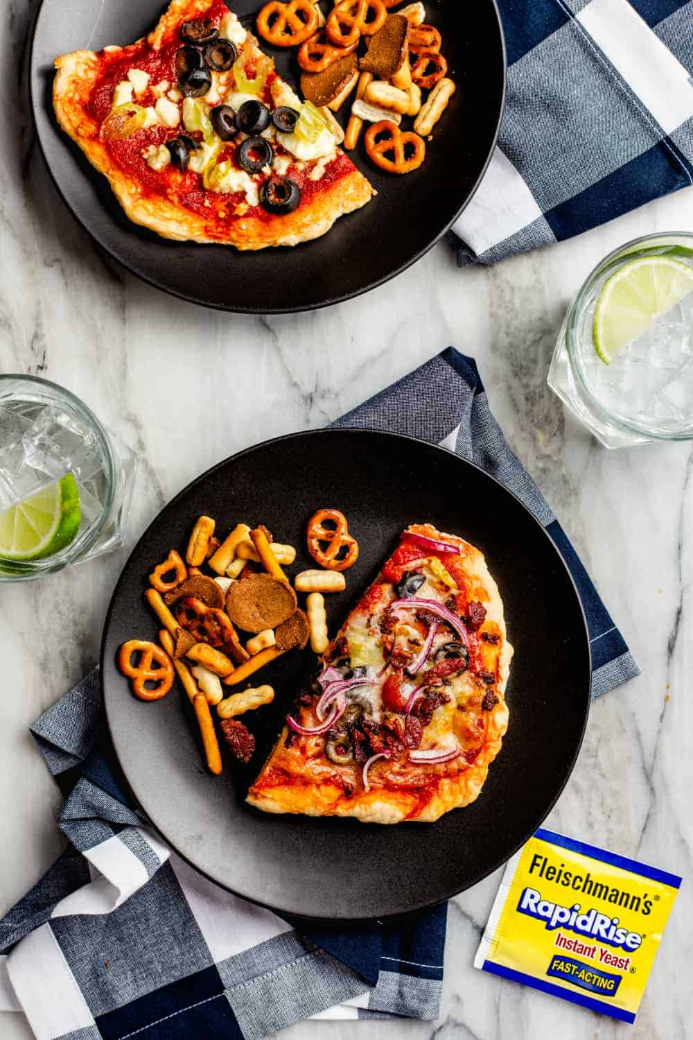 Homemade pizzas made from a DIY pizza bar served on black plates
