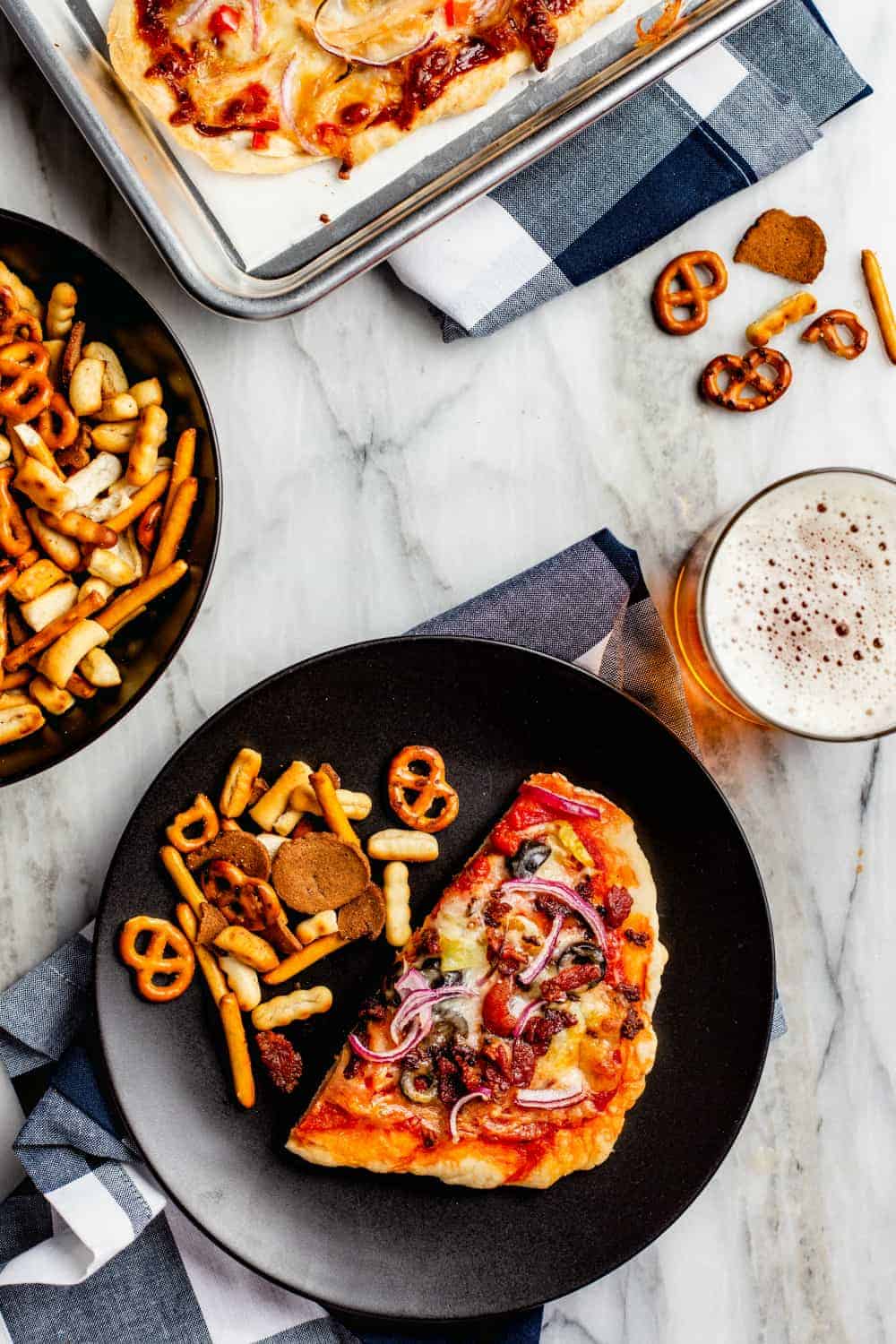 Homemade pizzas served with snack mix and drinks
