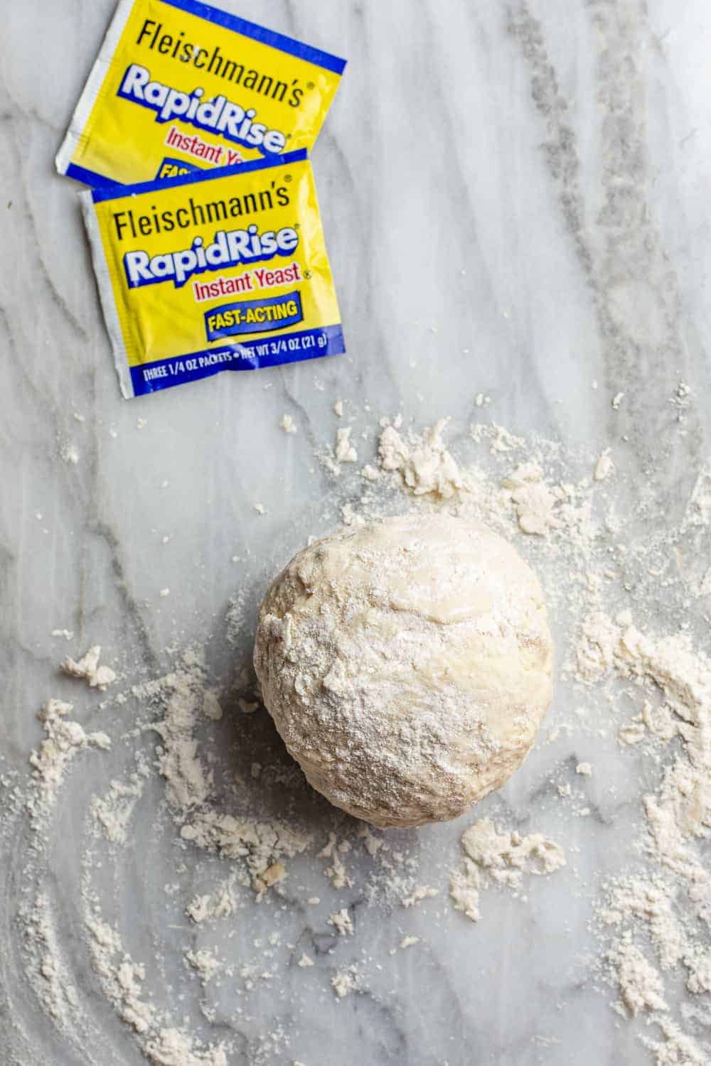Dough for 30 minute pizza crust on a floured marble surface
