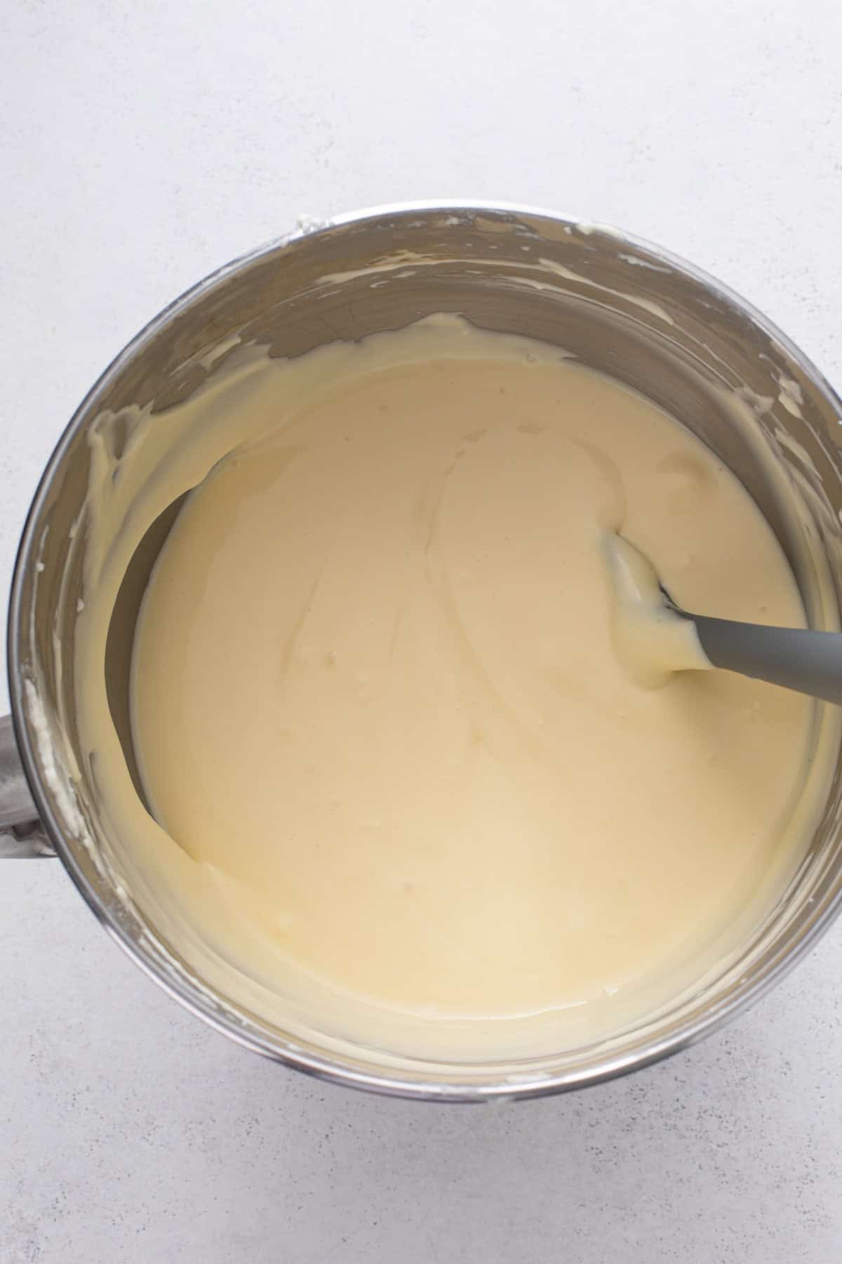 Marshmallow cheesecake batter ready to be added to a graham cracker crust.