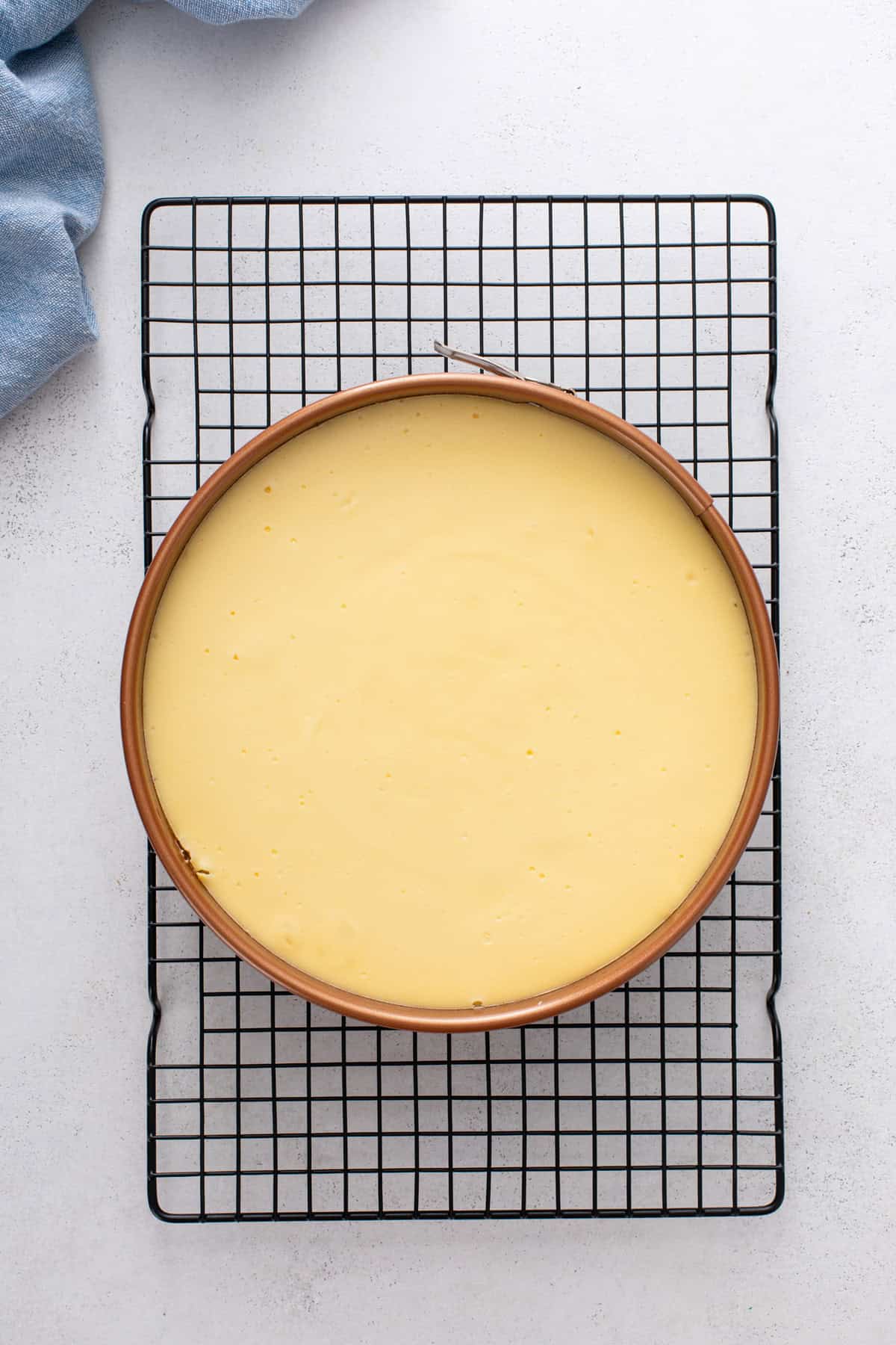 Baked s'mores cheesecake cooling on a wire rack.