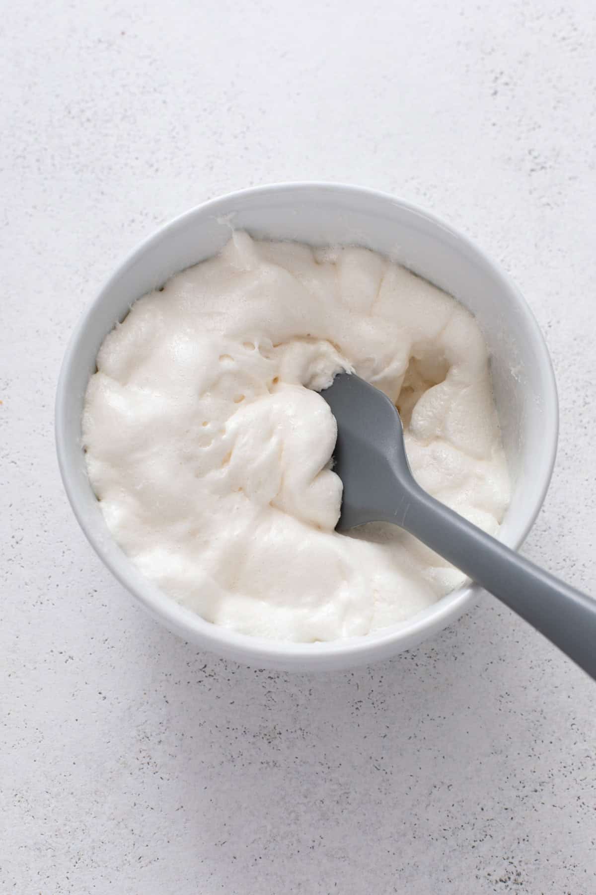 Melted marshmallows in a white bowl.