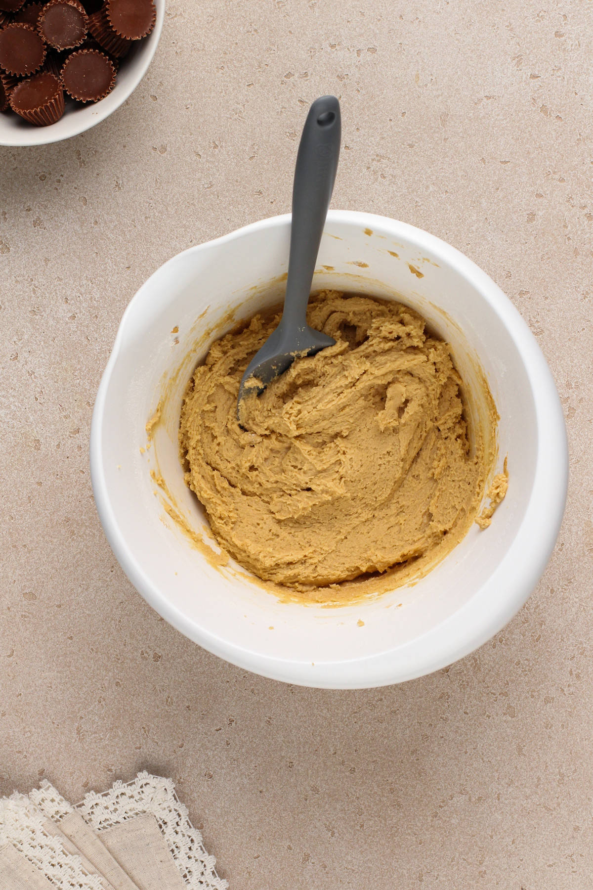 Peanut butter cookie dough in a white mixing bowl.