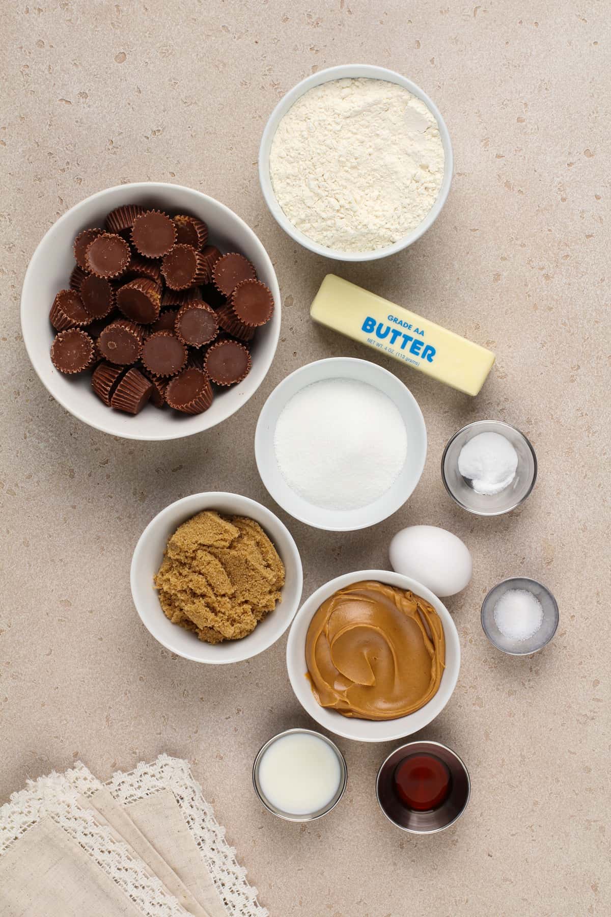 Peanut butter cup cookie ingredients arranged on a beige countertop.