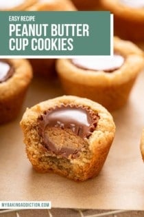 Bite from a peanut butter cup cookie, showing the peanut butter cup inside. Text overlay includes recipe name.