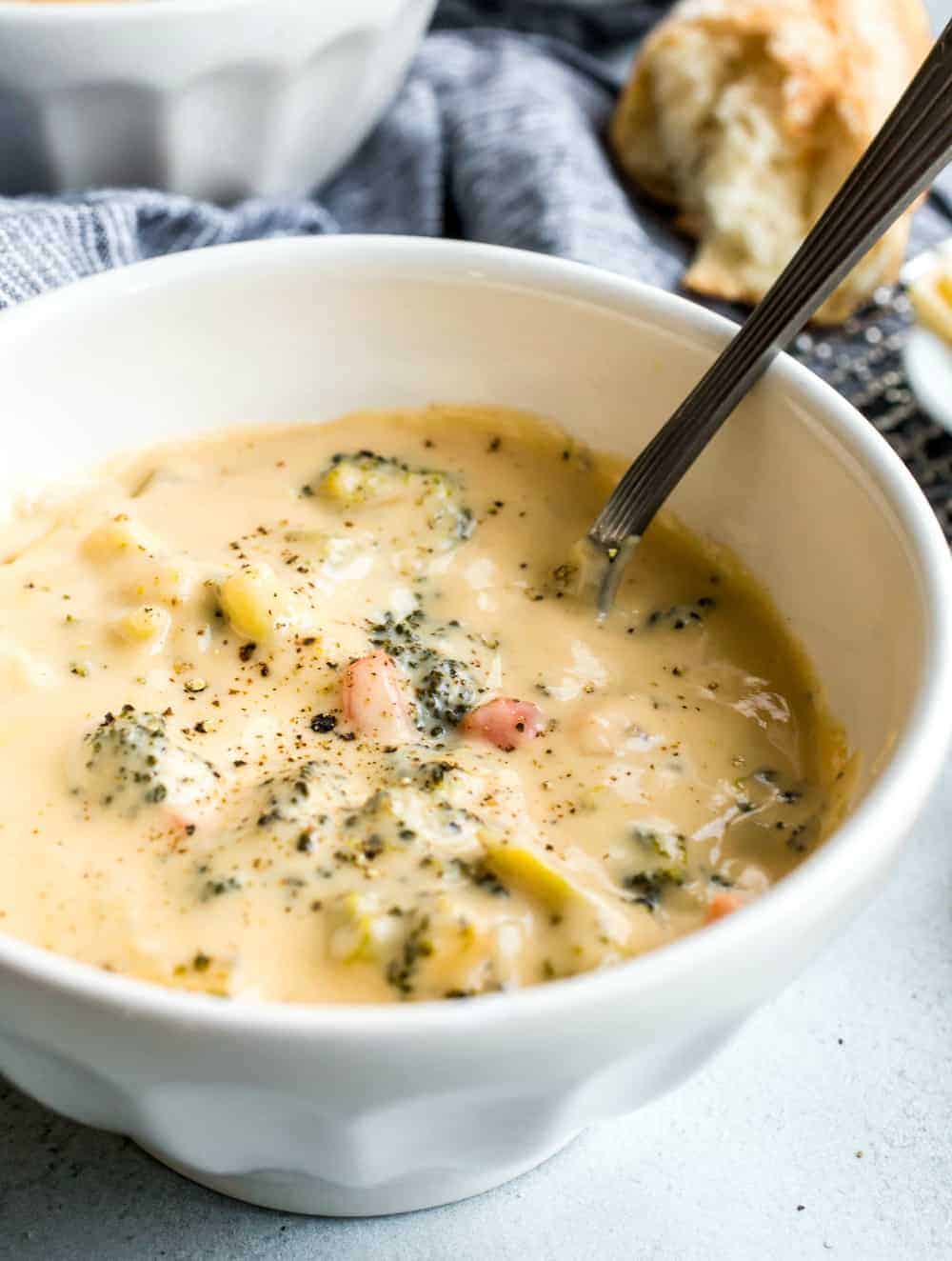 Close up on broccoli cheese soup in a white bowl