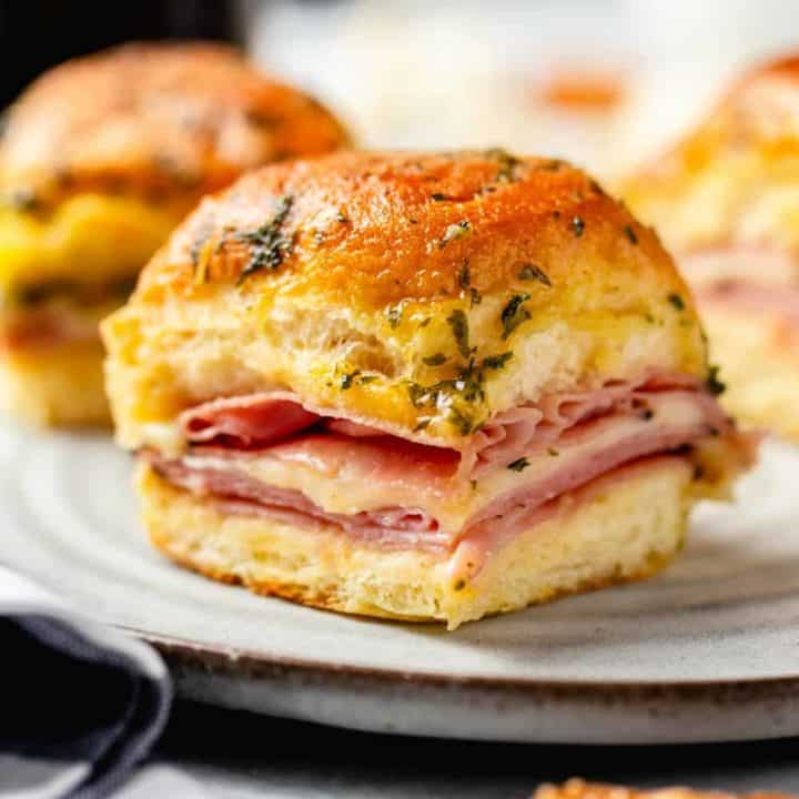 Close up of plated ham and cheese slider on a white plate