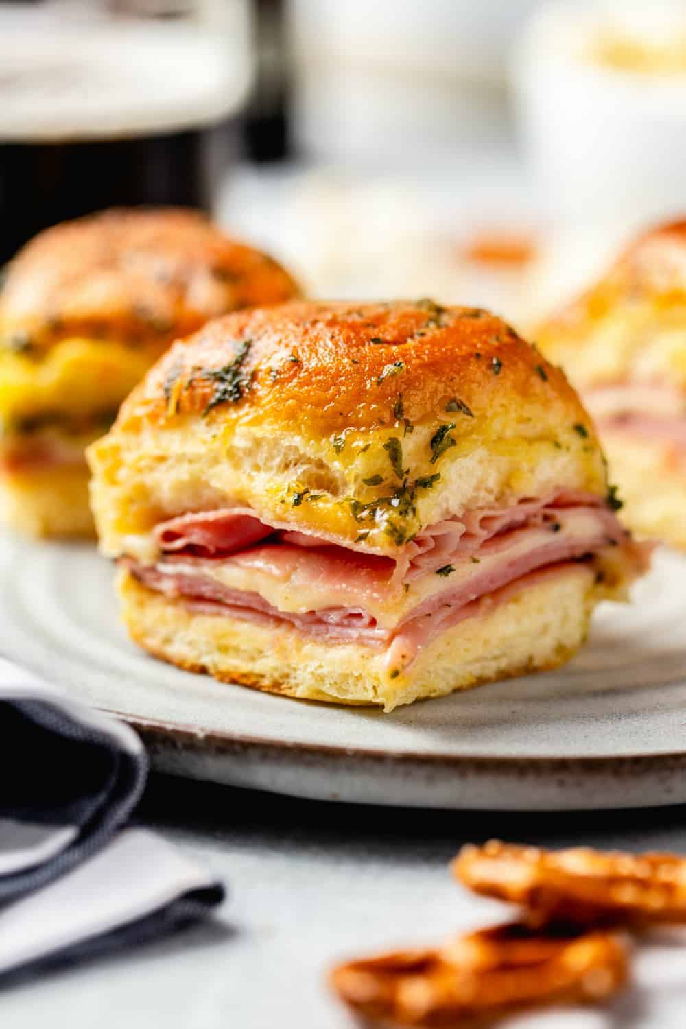 Close up of plated ham and cheese slider on a white plate