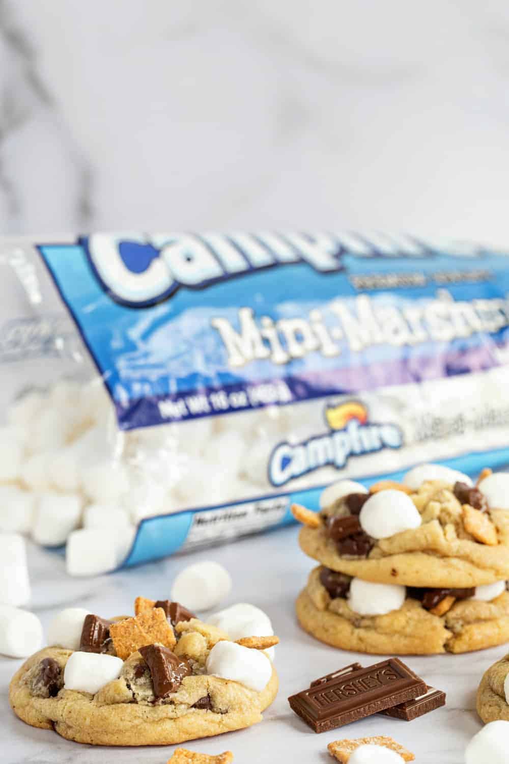 S'mores cookies on a marble countertop with a bag of mini marshmallows in the background