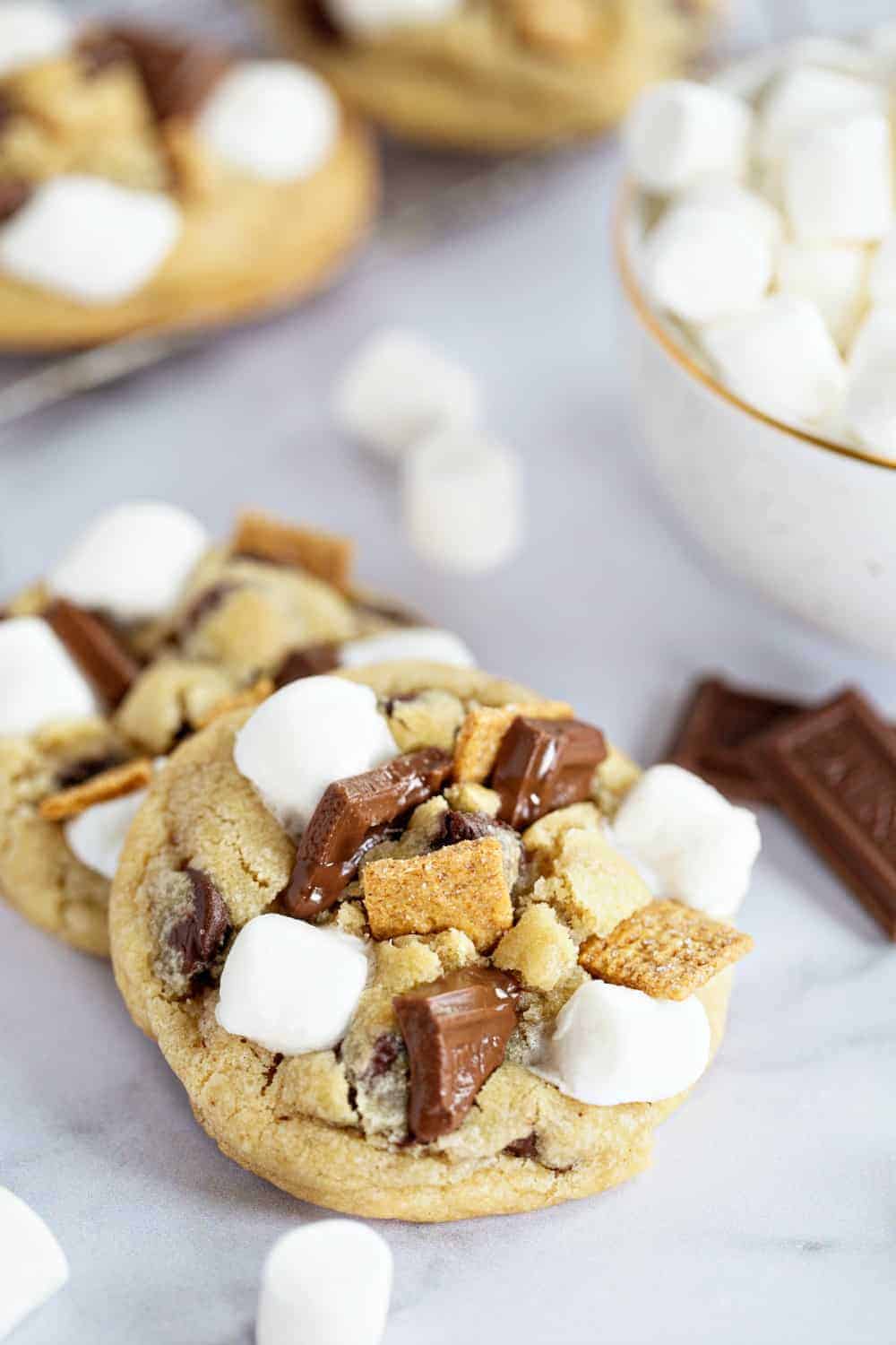 Close up of top of s'mores cookie with marshmallows, chocolate pieces and graham cracker cereal