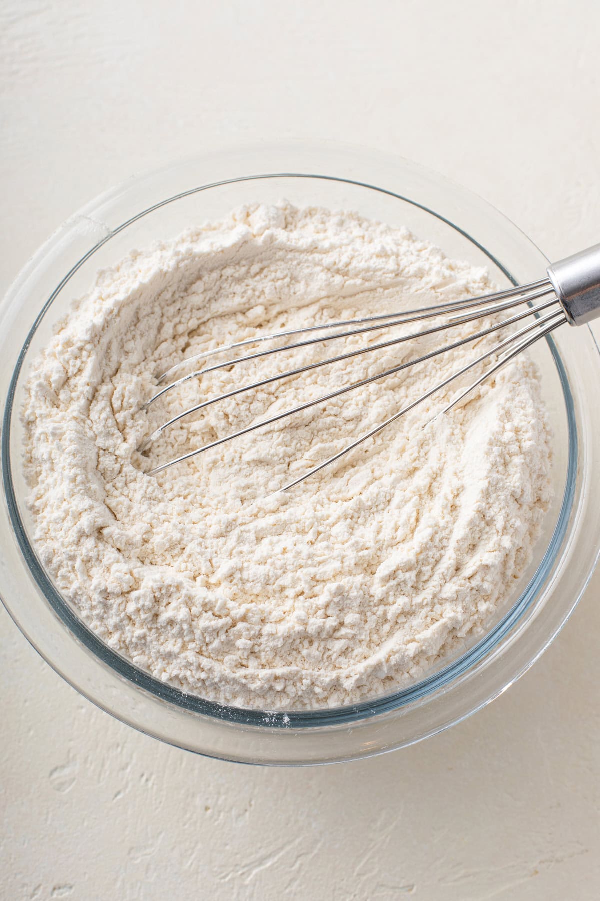 Dry ingredients for s'mores cookie dough whisked in a glass bowl.