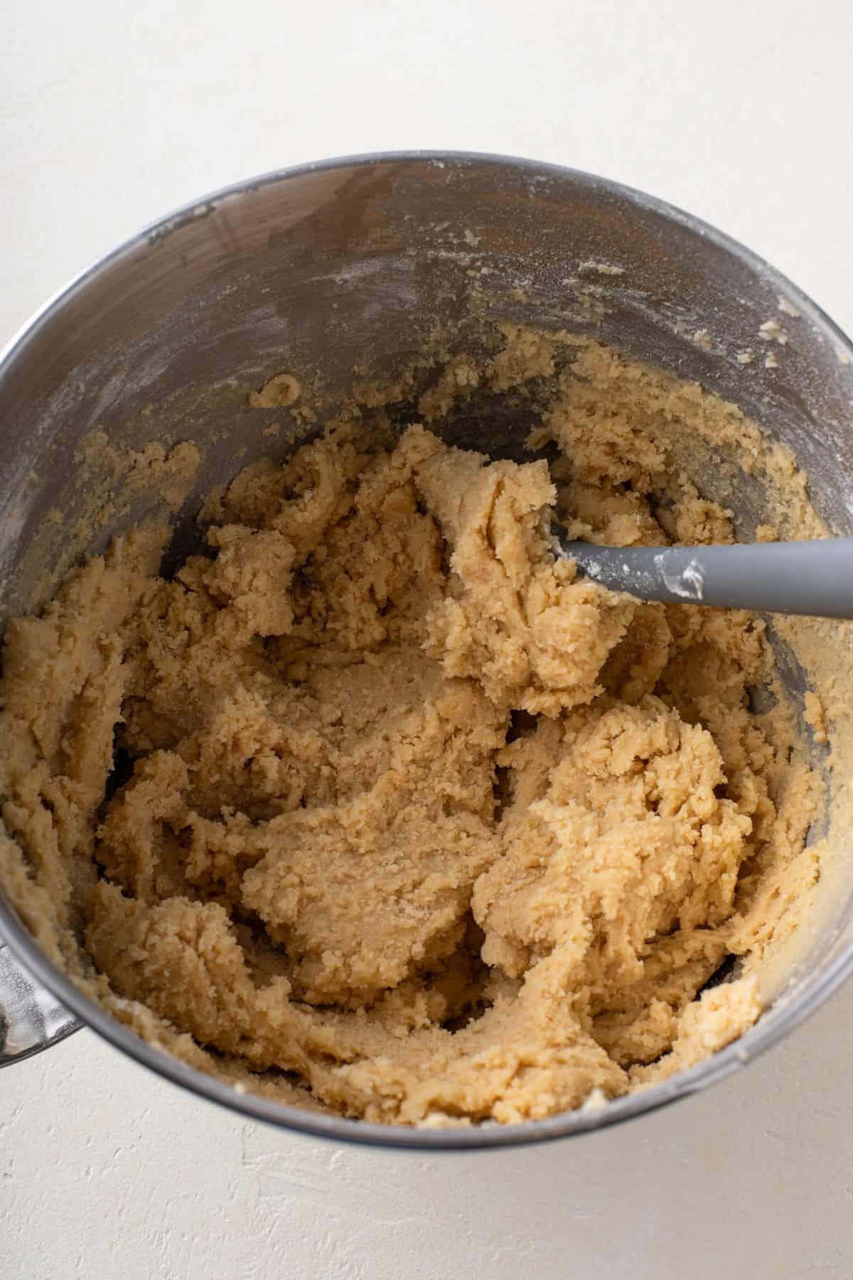 Dough base for s'mores cookies mixed in a bowl.