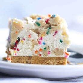 Close up of a slice of cookie dough cheesecake on a plate