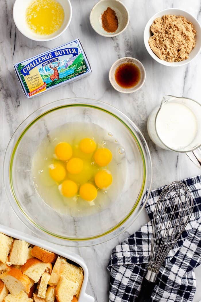 Overhead view of the ingredients for overnight french toast casserole set on a marble countertop