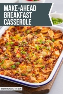 White casserole dish filled with baked make-ahead breakfast casserole. Text overlay includes recipe name.