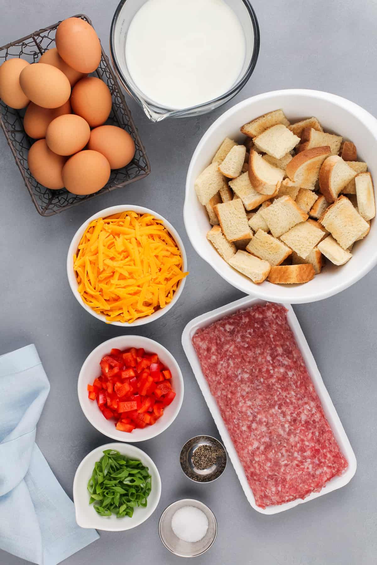 Ingredients for make-ahead breakfast casserole arranged on a gray countertop.