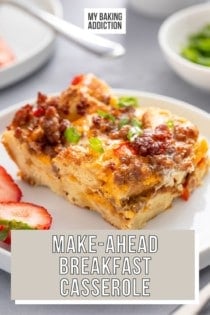 White plate holding a slice of make-ahead breakfast casserole. A second plate of casserole is visible in the backround. Text overlay includes recipe name.