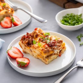 Slice of make-ahead breakfast casserole on a white plate.