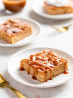 Three white plates with apple bars, each topped with a different topping