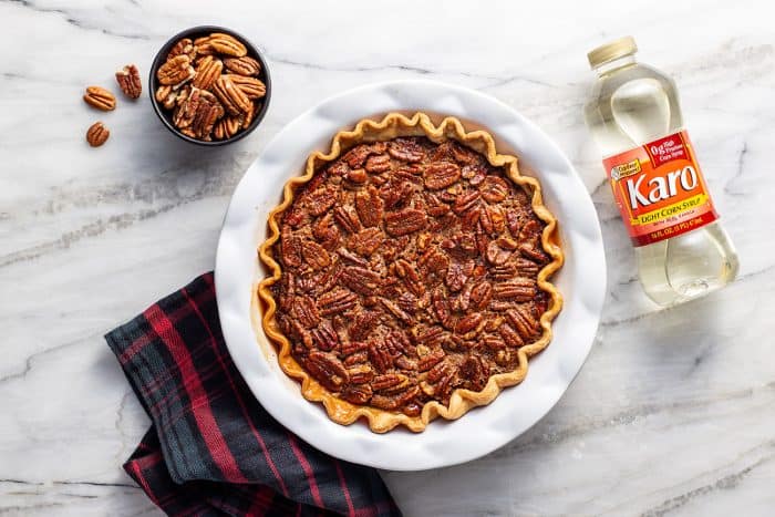 Overhead view of a chocolate pecan pie in a white pie plate