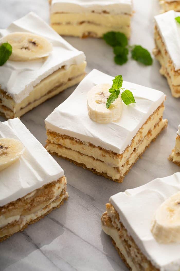 Slices of banana cream pie eclair cake arranged on a marble platter