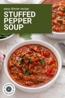 Two white bowls filled with stuffed pepper soup, garnished with fresh parsley. Text overlay includes recipe name.