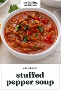 White bowl filled with stuffed pepper soup, garnished with parsley, resting next to texas toast on a countertop. Text overlay includes recipe name.