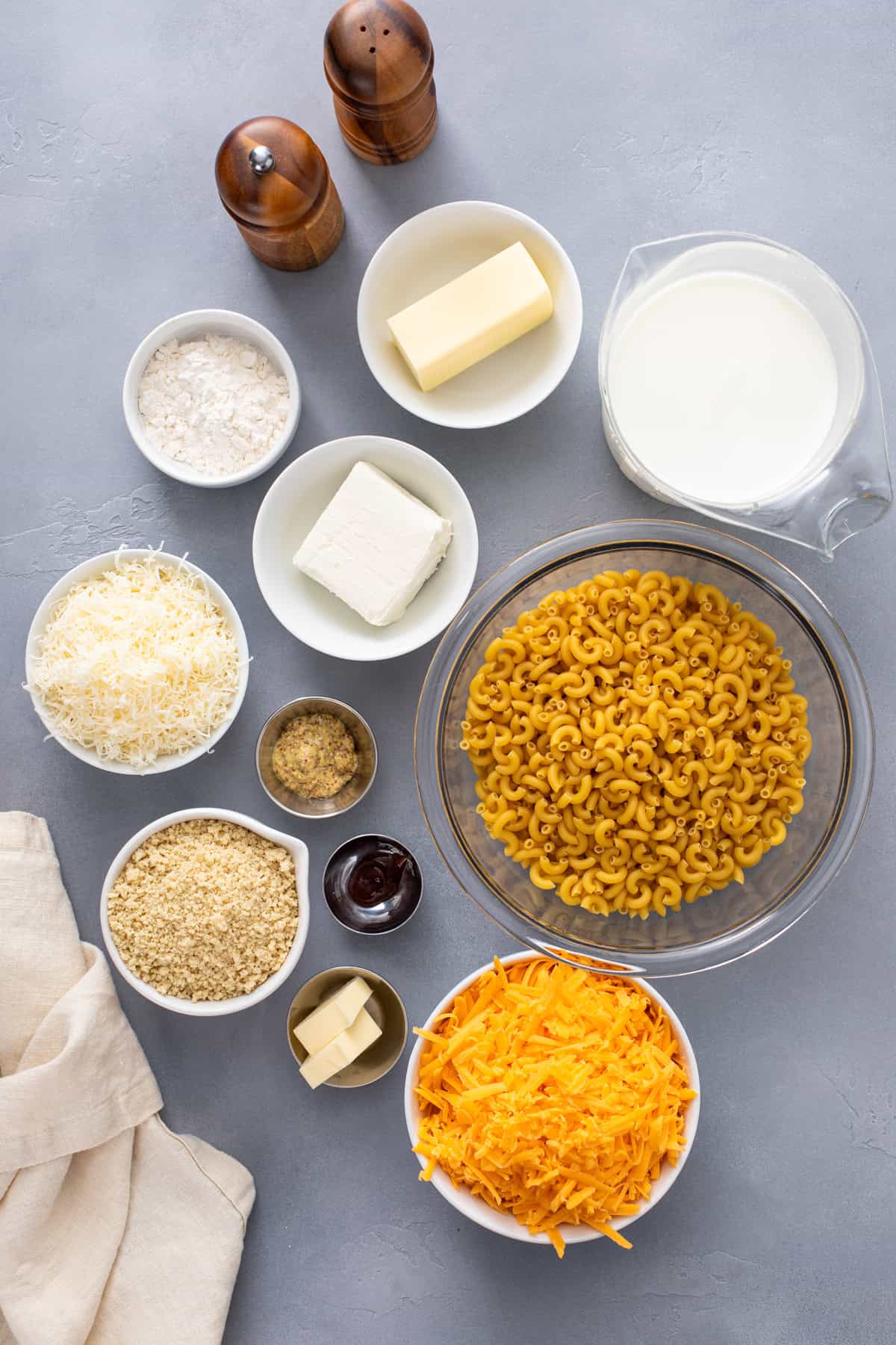 Baked mac and cheese ingredients arranged on a countertop.