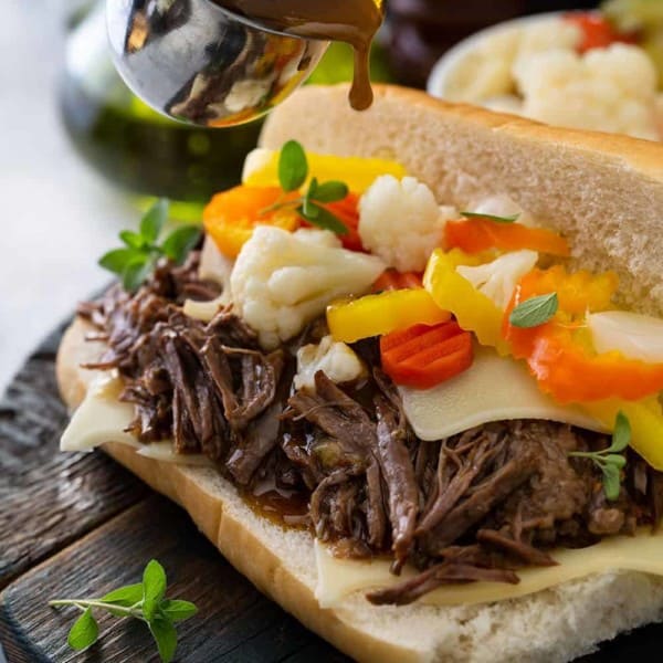 Assembled italian beef sandwich on a wooden board