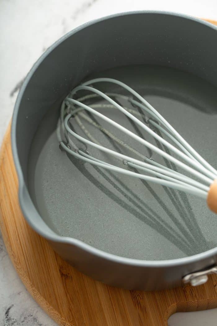 Whisk stirring simple syrup in a saucepan