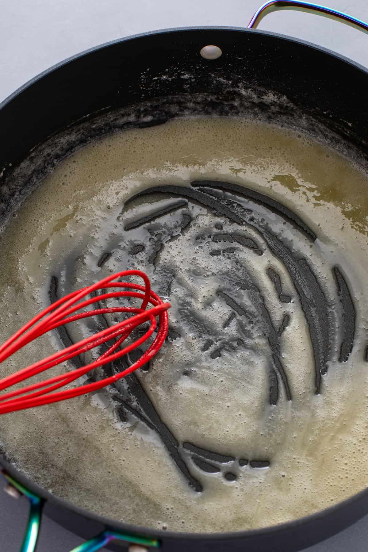 Roux for a cheese sauce in a skillet.