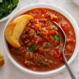 Spoon in a bowl of stuffed pepper soup.