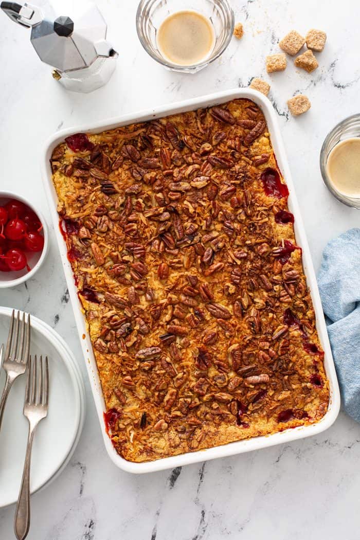 Baked cherry pineapple dump cake in a white cake pan