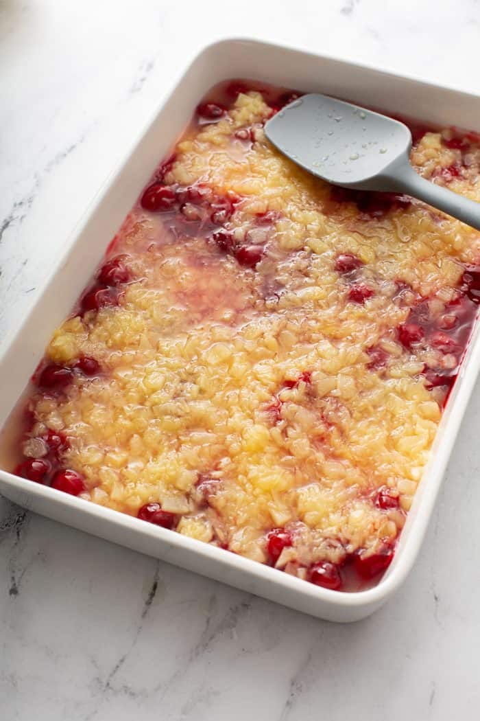 crushed pineapple and cherry pie filling layered in a cake pan