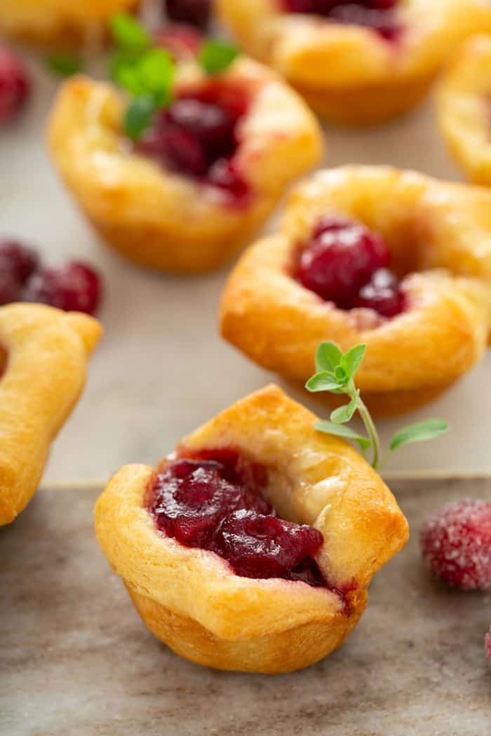 Close-up of cranberry brie bites arranged on a marble platter