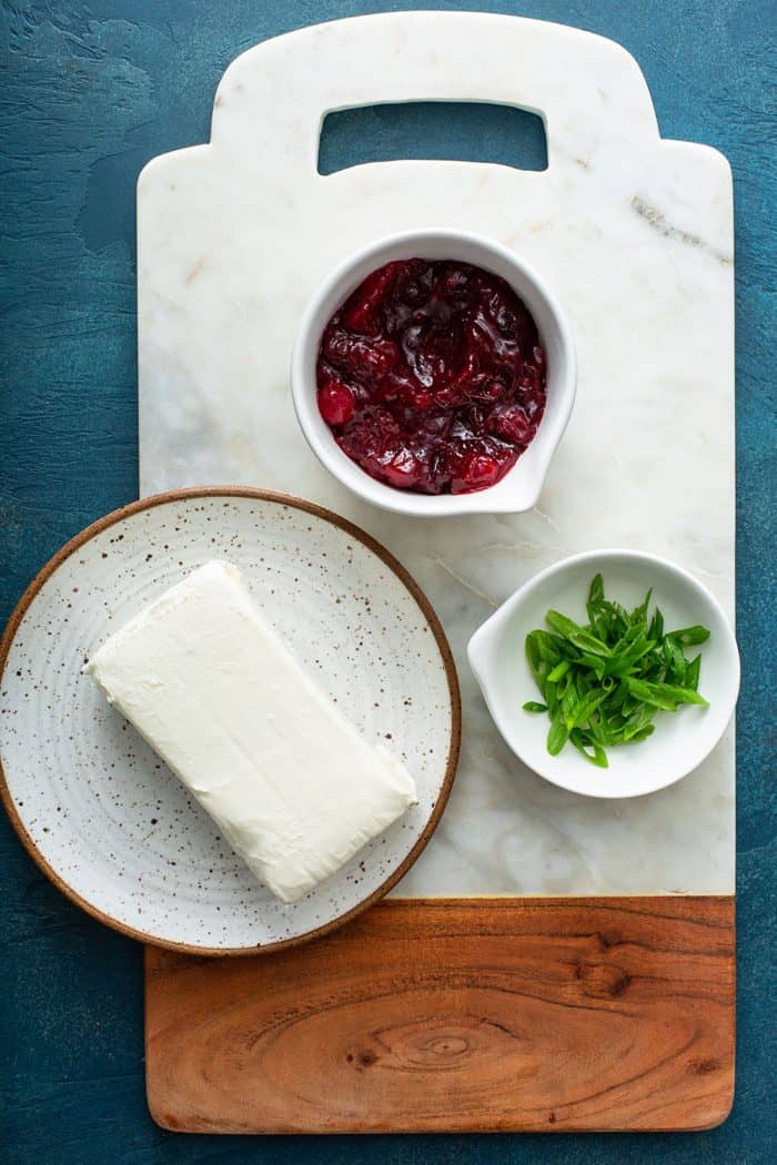 Ingredients for cranberry cream cheese dip on a marble board