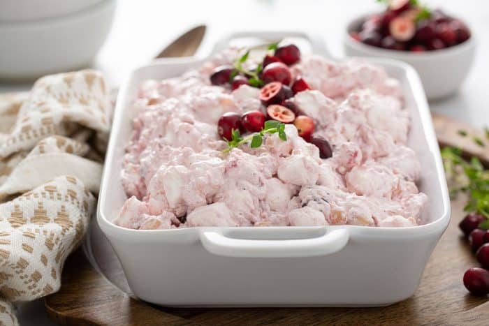 Cranberry fluff in a white serving dish, garnished with fresh cranberries