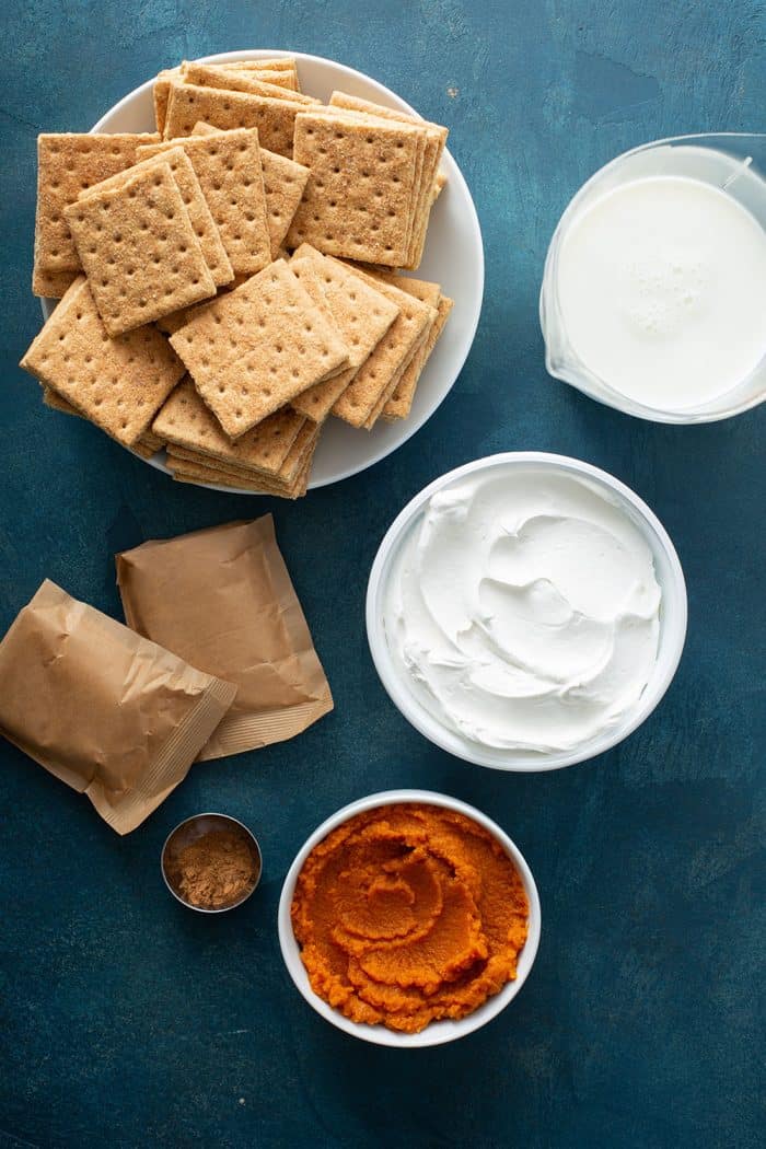 Ingredients for pumpkin eclair cake arranged on a counter