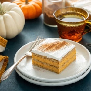 Plated slice of pumpkin eclair cake next to a fork