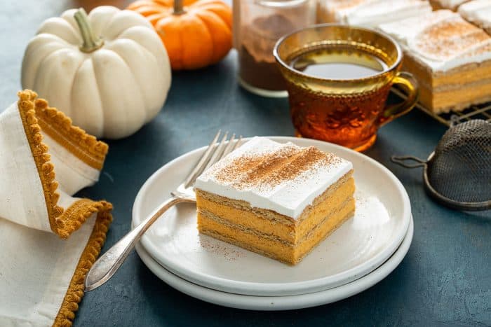 Plated slice of pumpkin eclair cake next to a fork