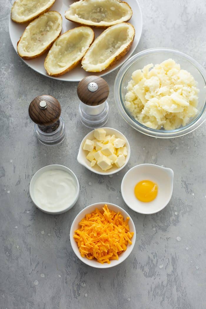 Ingredients for twice-baked potatoes on a gray countertop