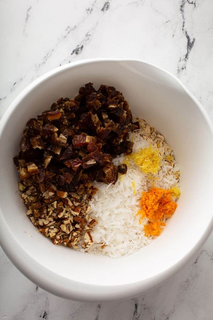 Dry ingredients for ambrosia cookies in a white mixing bowl