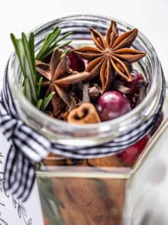 Close up of the open mouth of a glass jar filled with stovetop potpourri