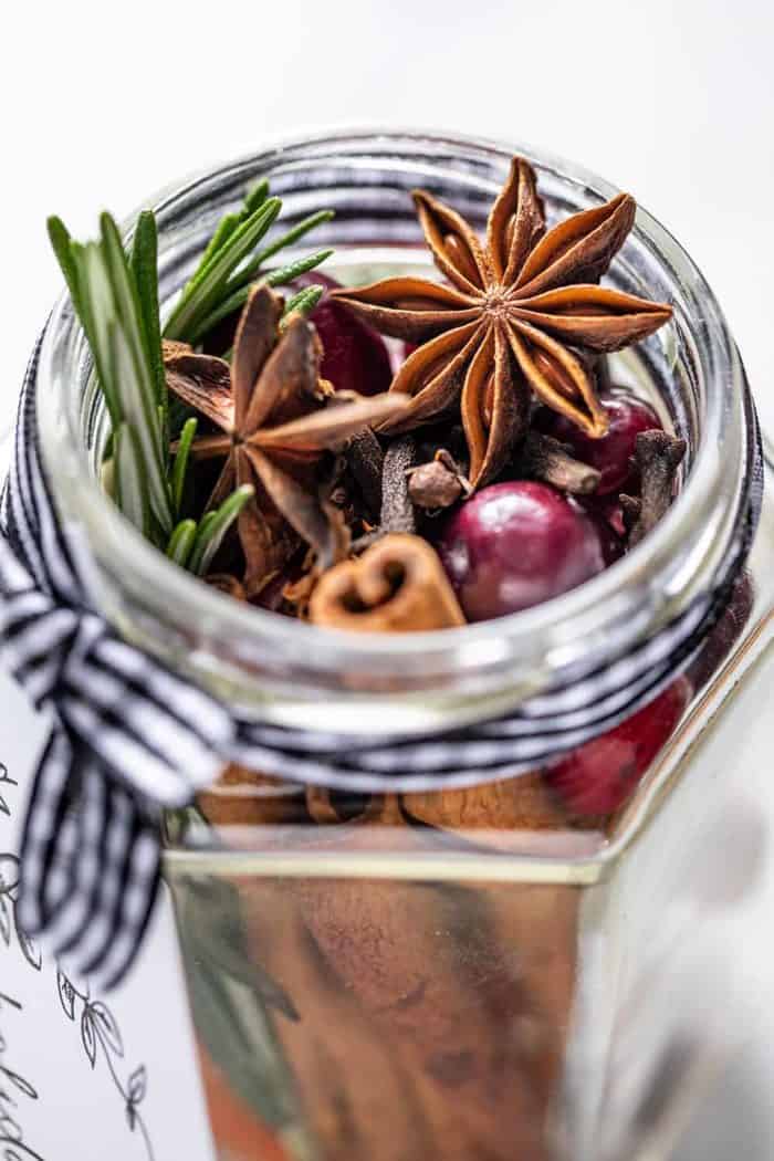 Close up of the open mouth of a glass jar filled with stovetop potpourri