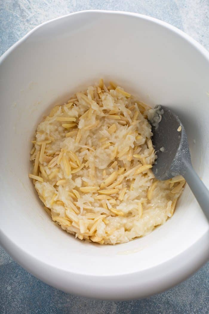 Coconut macaroon dough in a white mixing bowl