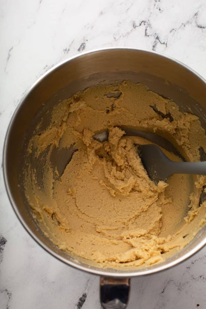 Cookie dough mixed in a metal mixing bowl