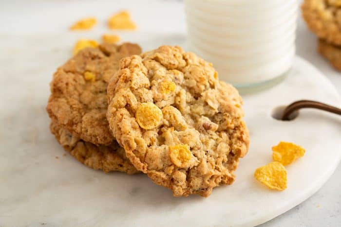 Cornflake cookies stacked on a marble platter