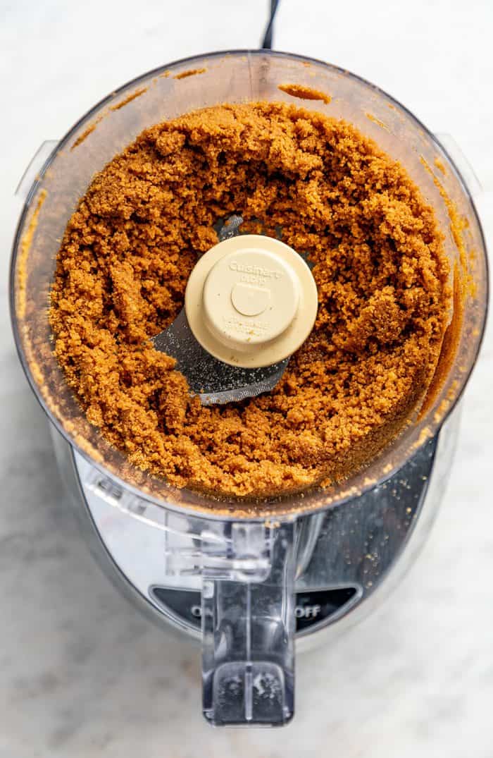 Gingersnap cookie crumbs in the bowl of a food processor