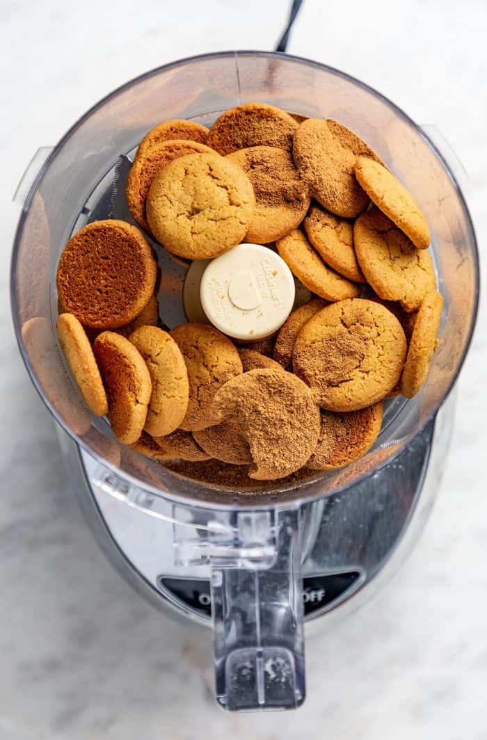 gingersnap cookies and pumpkin pie spice in the bowl of a food processor