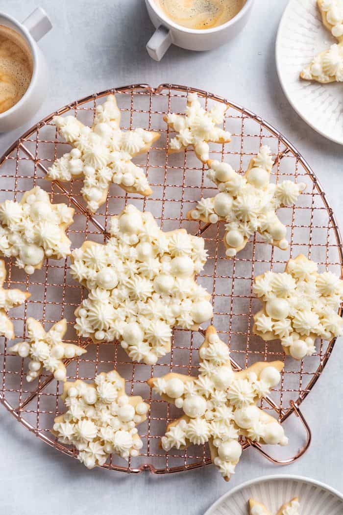 Decorated snowflake sugar cookies on a wire rack